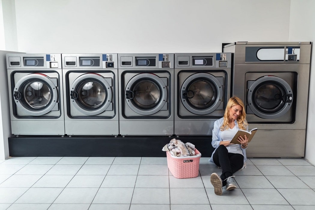 woman-reading-inside-laundromat-min-min-min